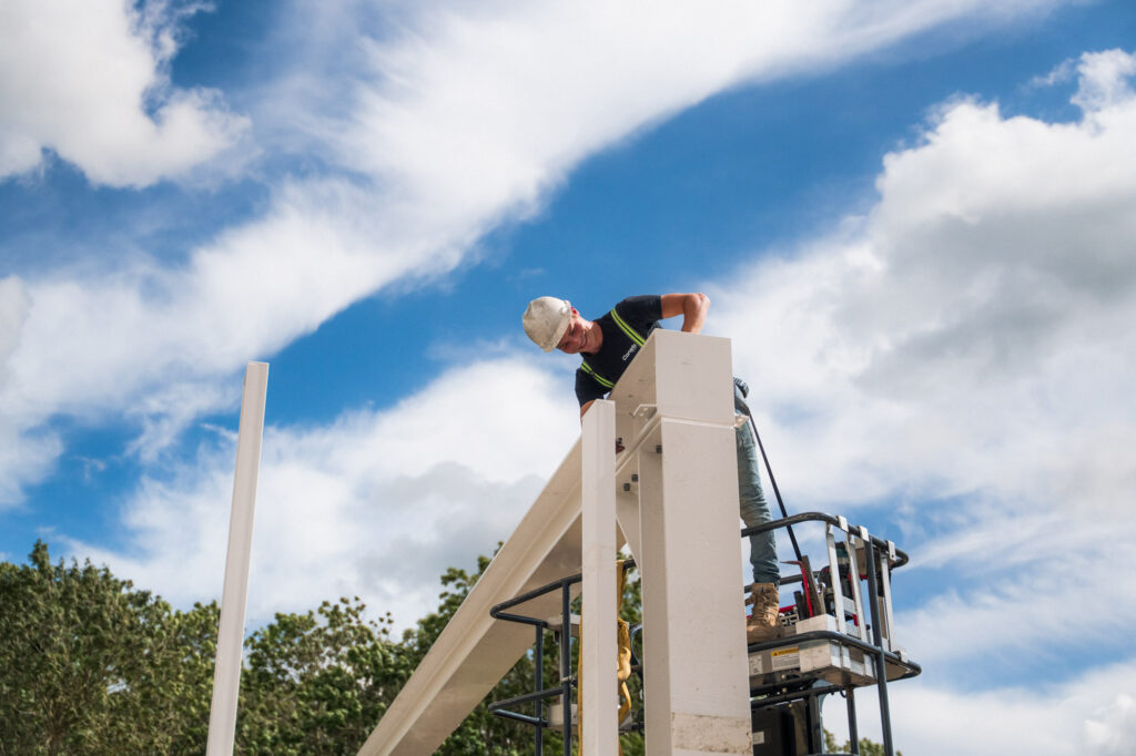 Monteur werkt op hoogte aan de staalconstructie